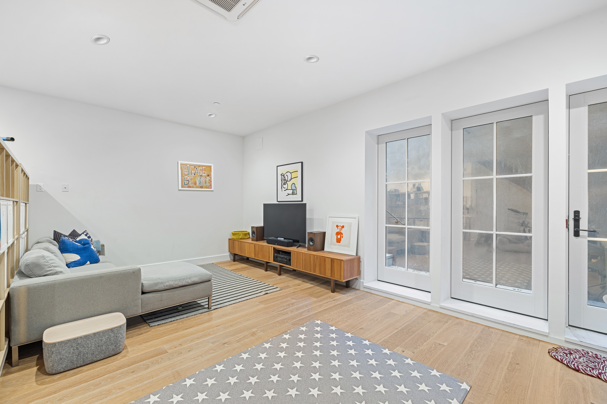 49 East 4th Street Brooklyn, NY 11218 - Photo 13 of 16 a living room with furniture and a window