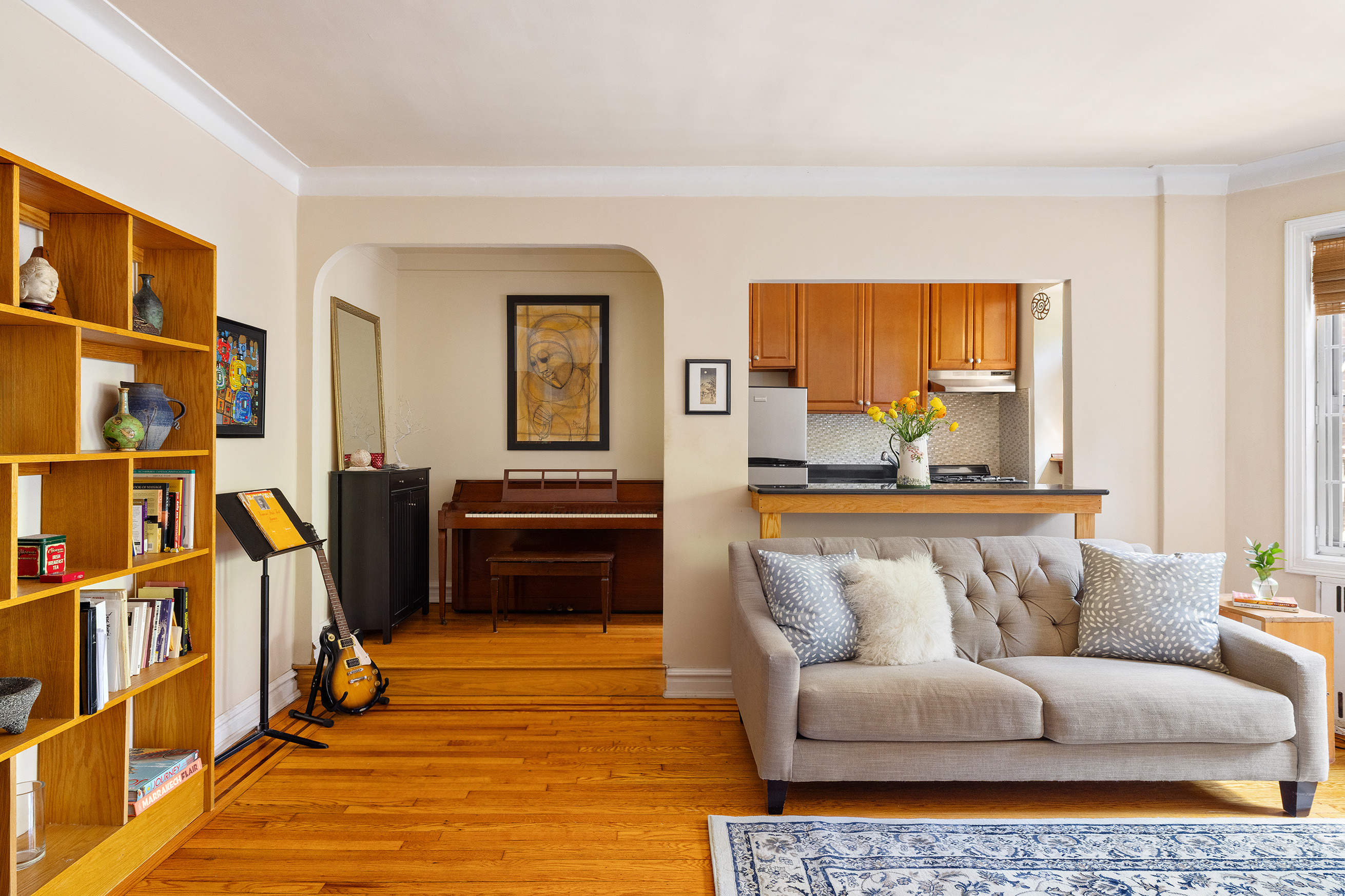 34-24 82nd Street, Unit 2B Queens, NY 11372 - Photo 2 of 8 a living room with furniture and a piano