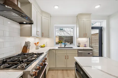 a kitchen with a stove a sink and a refrigerator