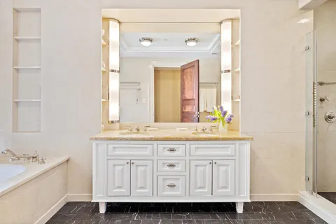 a bathroom with a granite countertop sink and a mirror