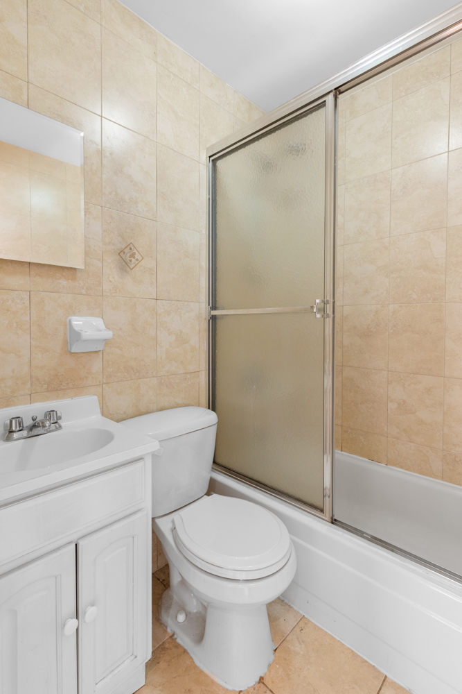 176 Bergen Street, Unit 2 Brooklyn, NY 11217 - Photo 4 of 4 a bathroom with a sink a toilet and shower