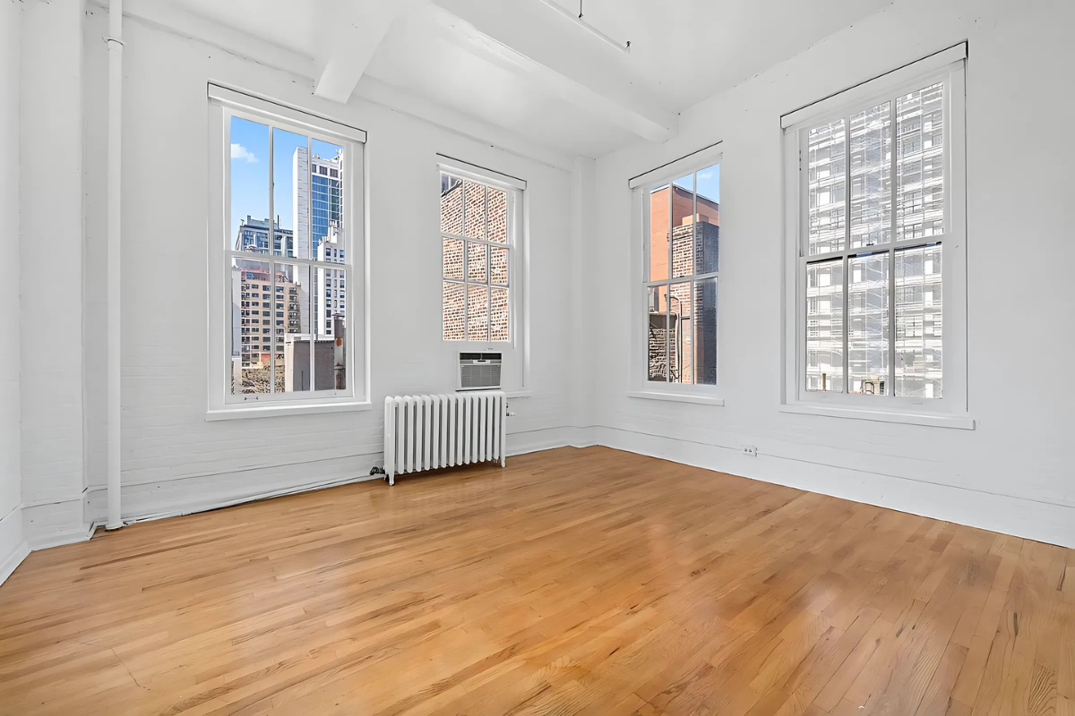 448 West 37th Street, Unit 6H Manhattan, NY 10018 - Photo 4 of 9 a view of an empty room with a window