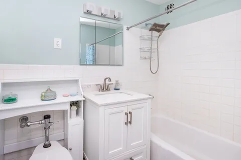 a bathroom with a sink a vanity and a bathtub