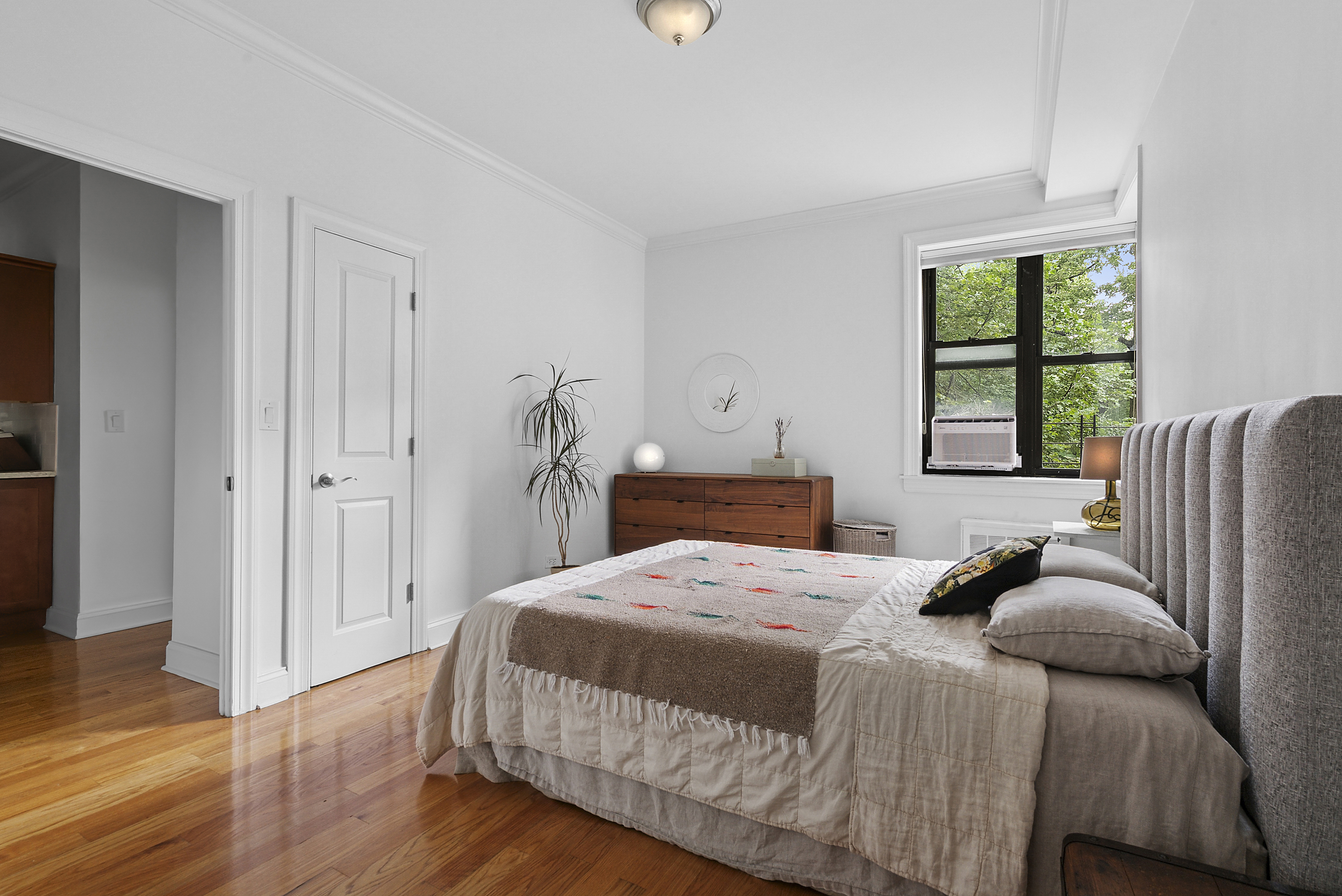 273 Bennett Avenue, Unit 3F Manhattan, NY 10040 - Photo 5 of 9 a bedroom with a bed and wooden floor