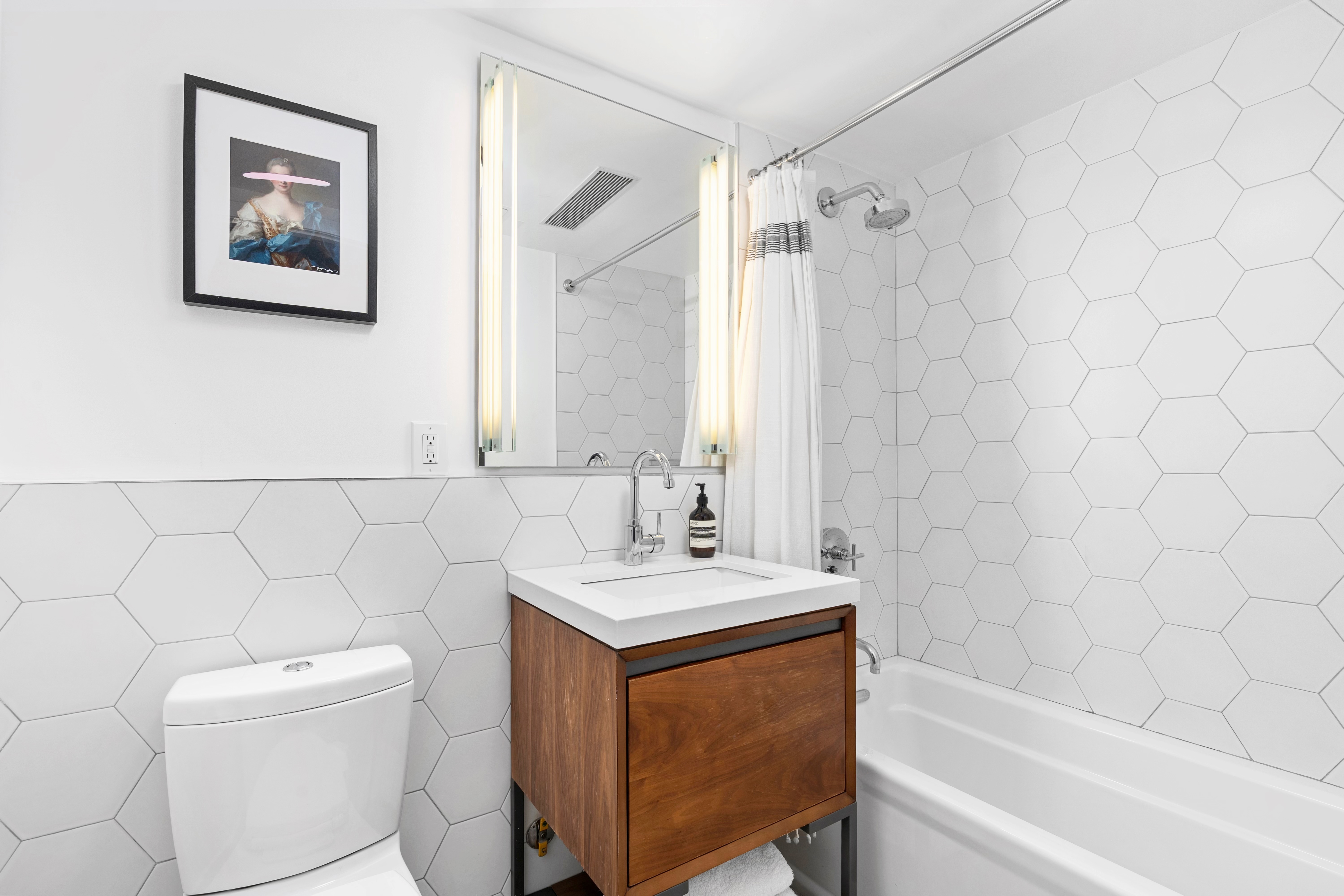 245 Manhattan Avenue, Unit 2A Brooklyn, NY 11211 - Photo 9 of 10 a bathroom with a sink a toilet and a bathtub