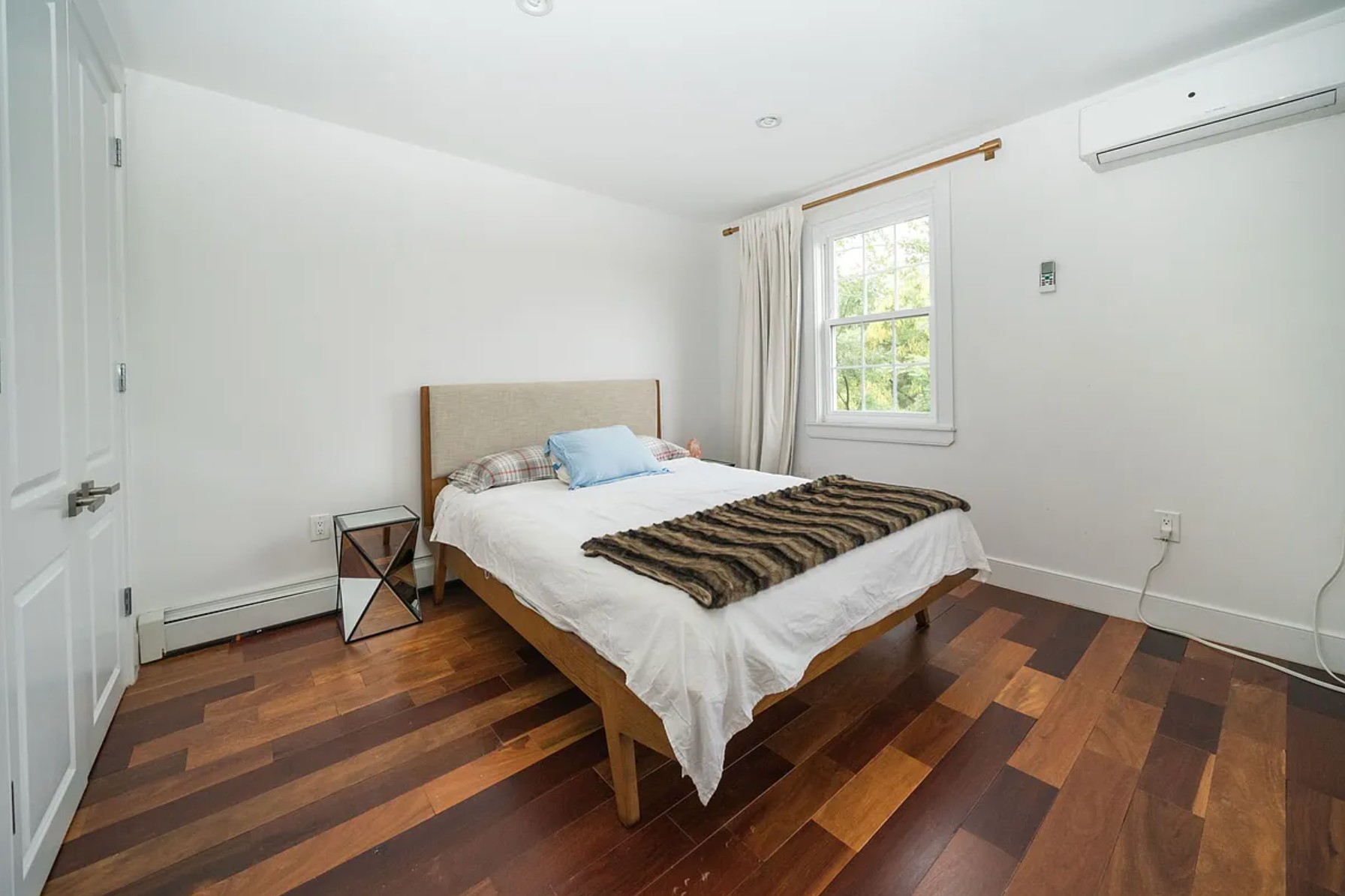 29 Melrose Street, Unit 2 Brooklyn, NY 11206 - Photo 9 of 13 a bedroom with a bed and wooden floor