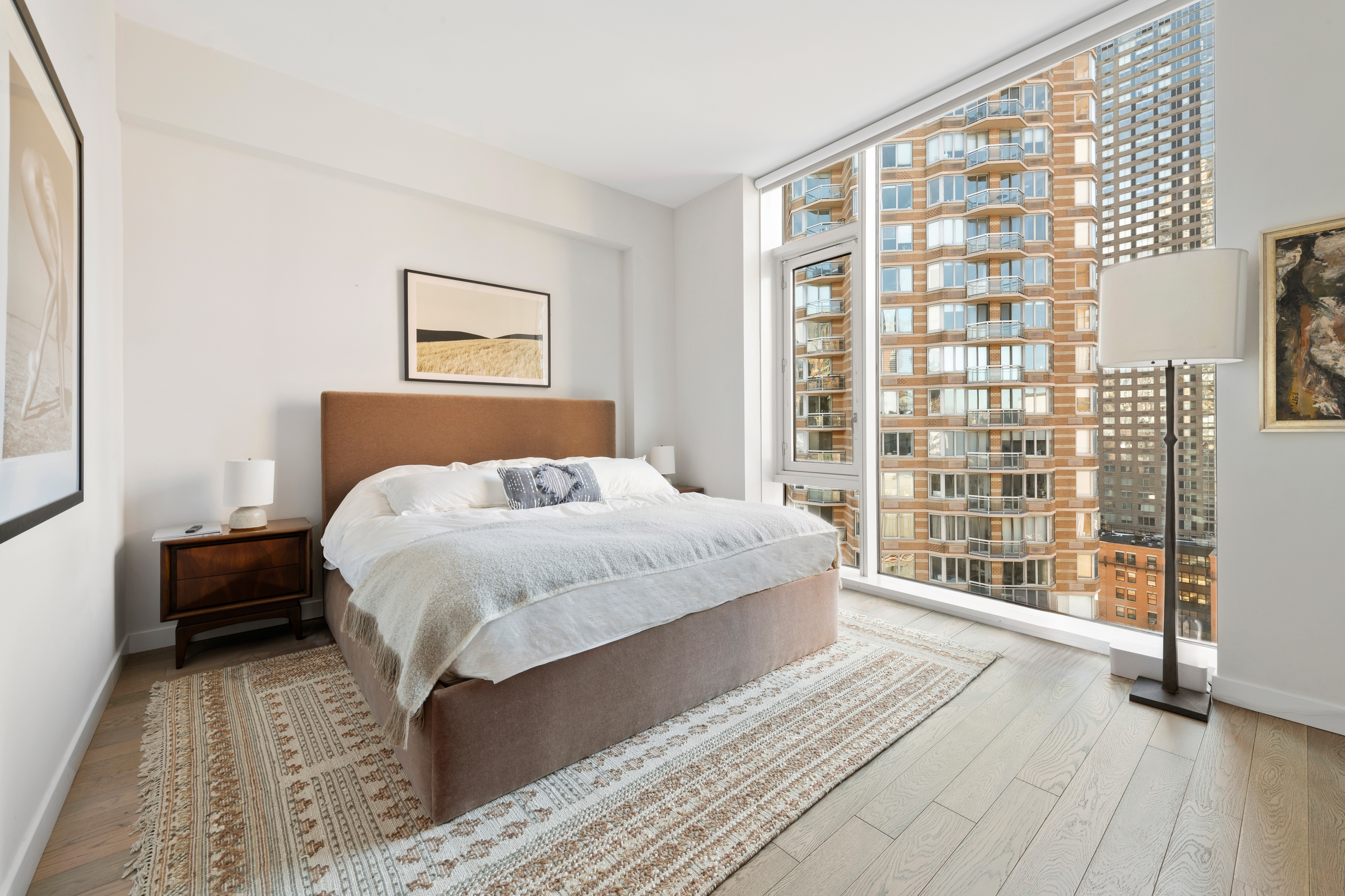 505-513 West 43rd Street, Unit PHG Manhattan, NY 10036 - Photo 7 of 20 a bedroom with a large bed and a large window
