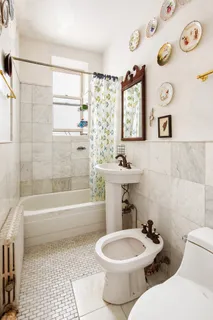 a bathroom with a toilet a sink and a bathtub
