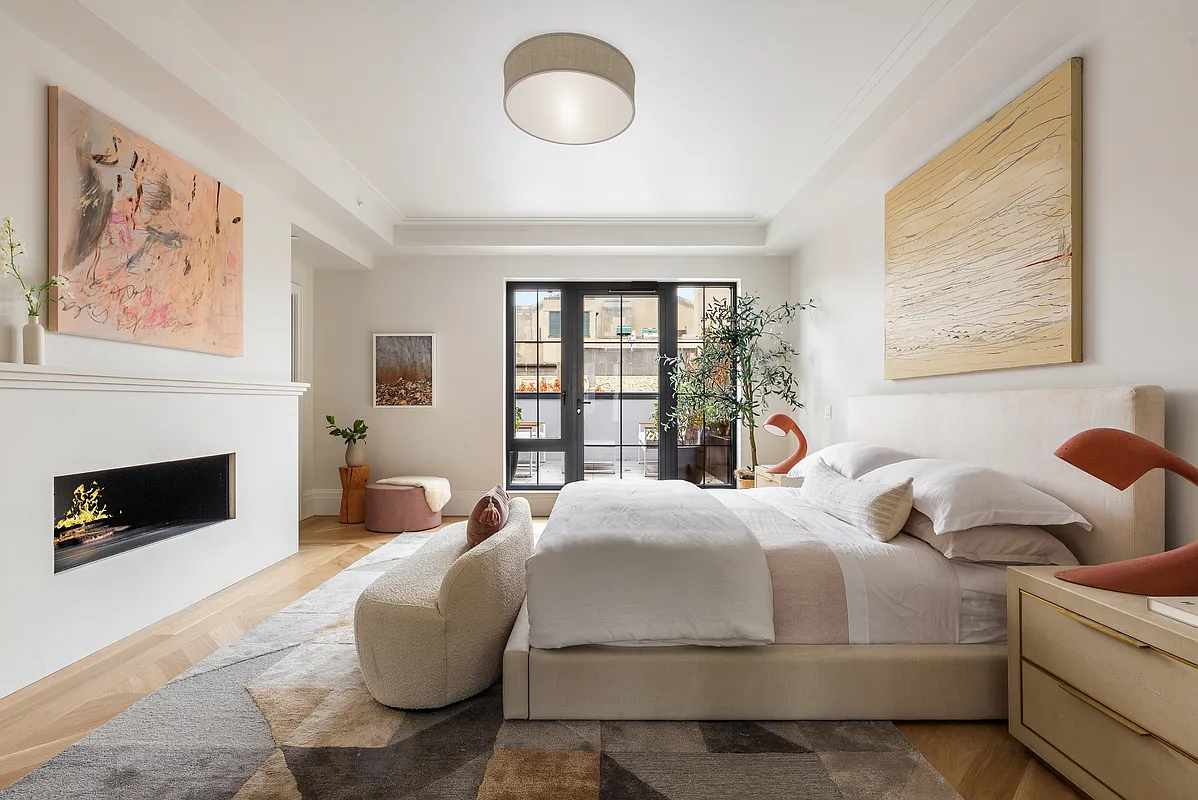 537 Pacific Street Brooklyn, NY 11217 - Photo 13 of 25 a bedroom with a bed and a fireplace