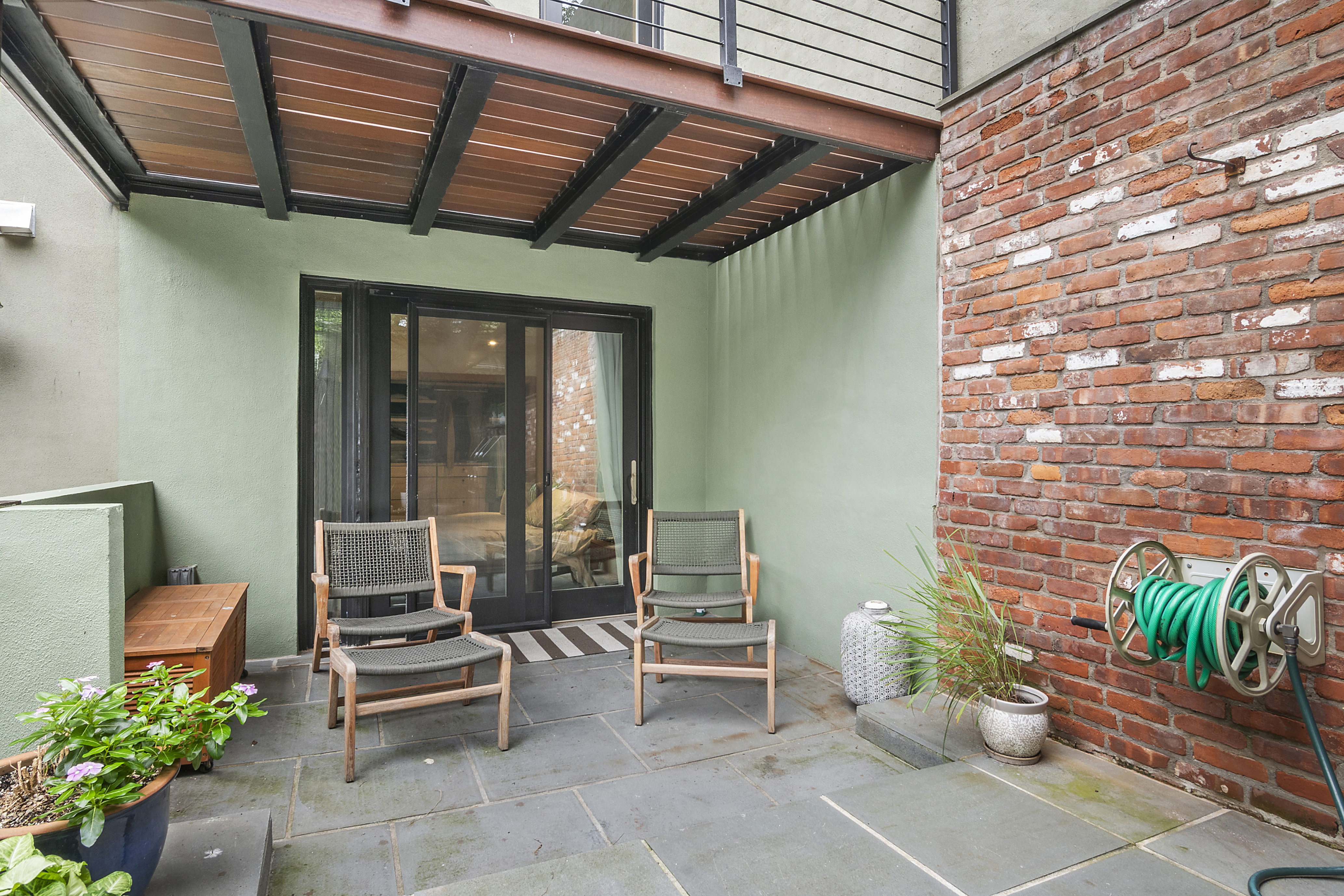 87 Monroe Street Brooklyn, NY 11216 - Photo 22 of 26 a outdoor living space with furniture and a potted plant