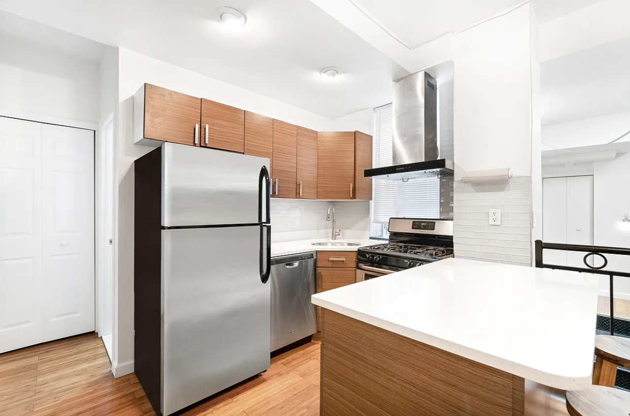 326 22nd Street, Unit 1R Brooklyn, NY 11215 - Photo 2 of 9 a kitchen with a refrigerator a stove and wooden floor