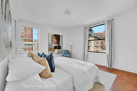 a bedroom with a large bed and a window