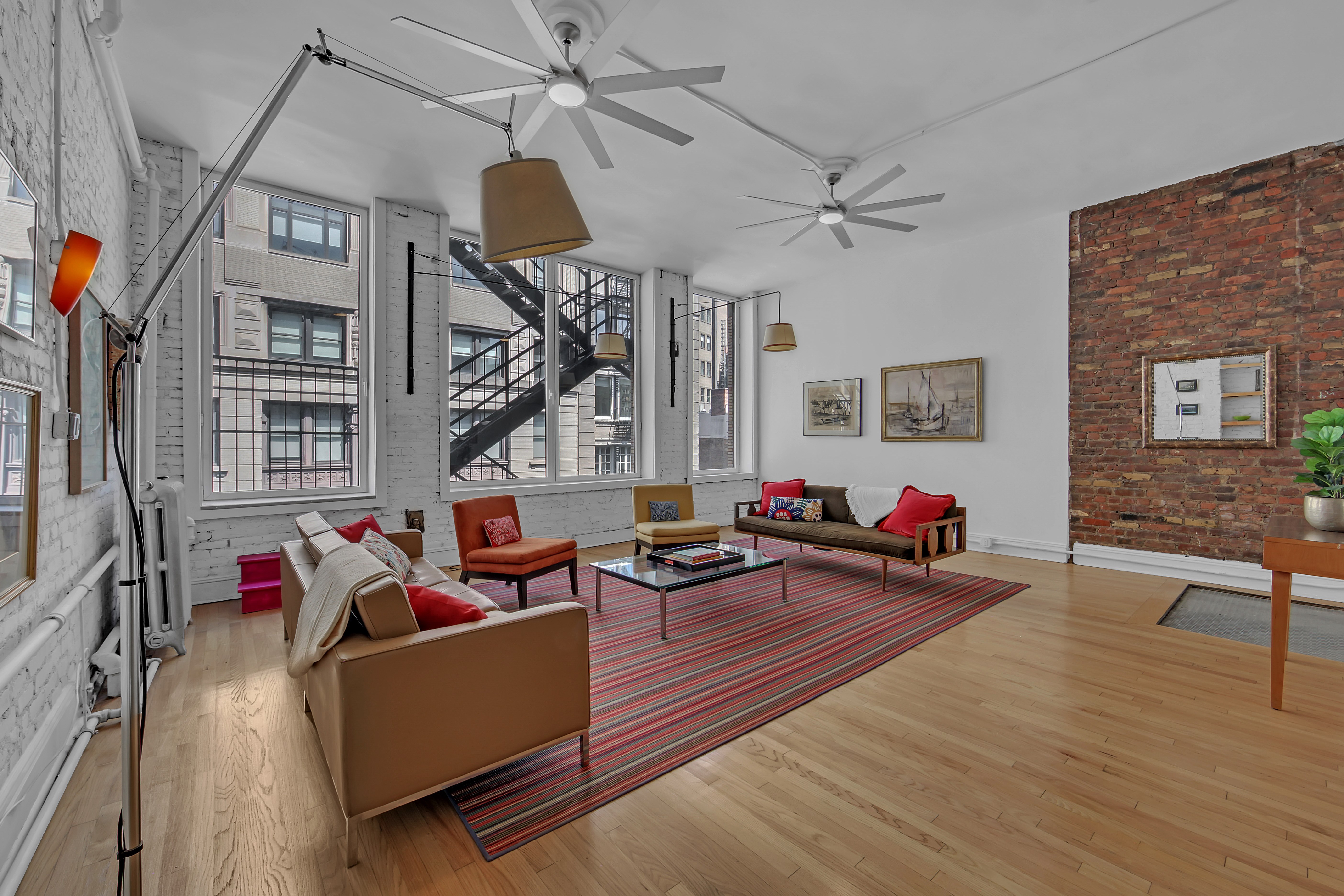 56 East 11th Street, Unit 7 Manhattan, NY 10003 - Photo 5 of 18 a living room with furniture and a wooden floor