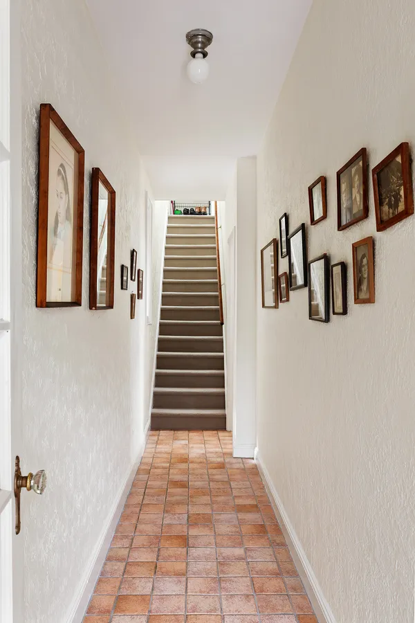 a view of a livingroom with wooden floor and stairs