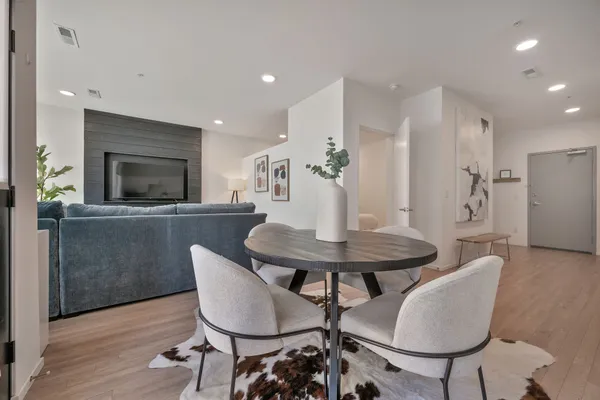 a view of a dining room with furniture and wooden floor