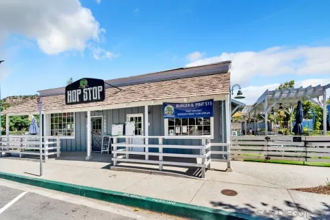 a front view of a house with fountain and outdoor seating