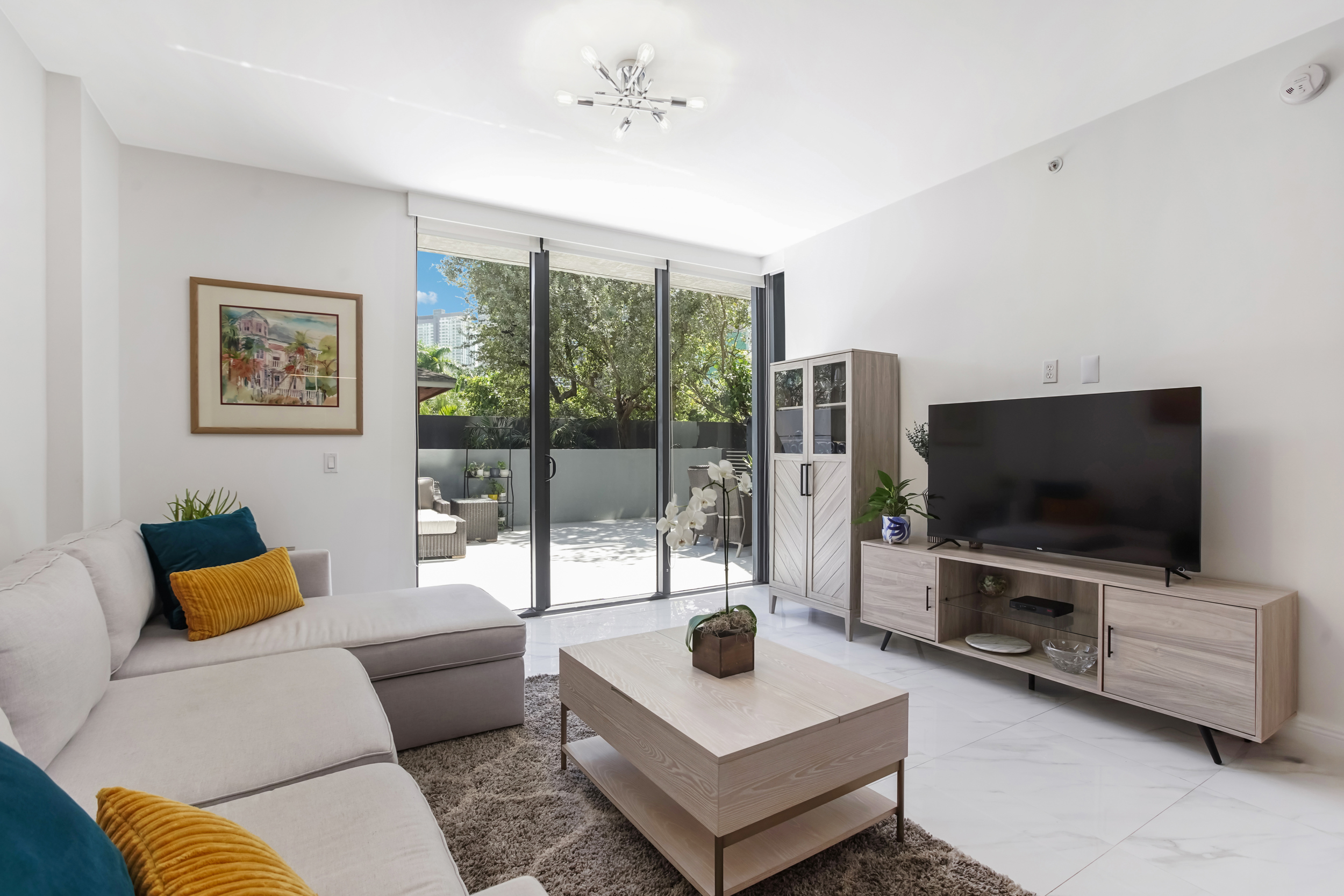 201 Southwest 17th Road, Unit 311 Miami, FL 33129 - Photo 9 of 21 a living room with furniture and a flat screen tv