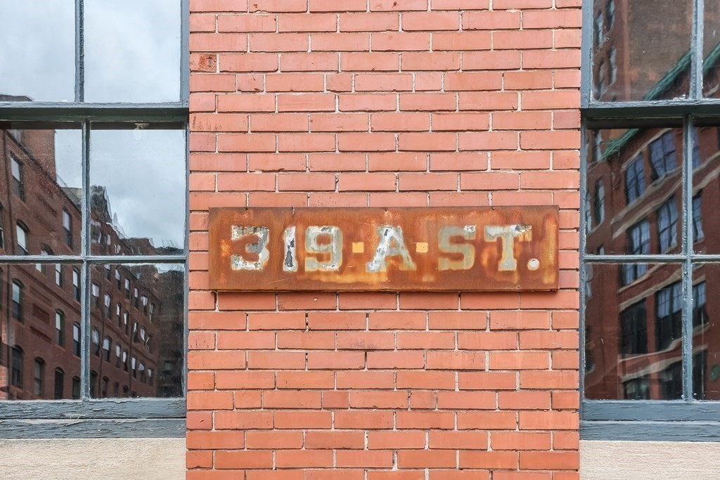 319 A Street, Unit 211 Boston, MA 02210 - Photo 23 of 24 a brick building with a street sign