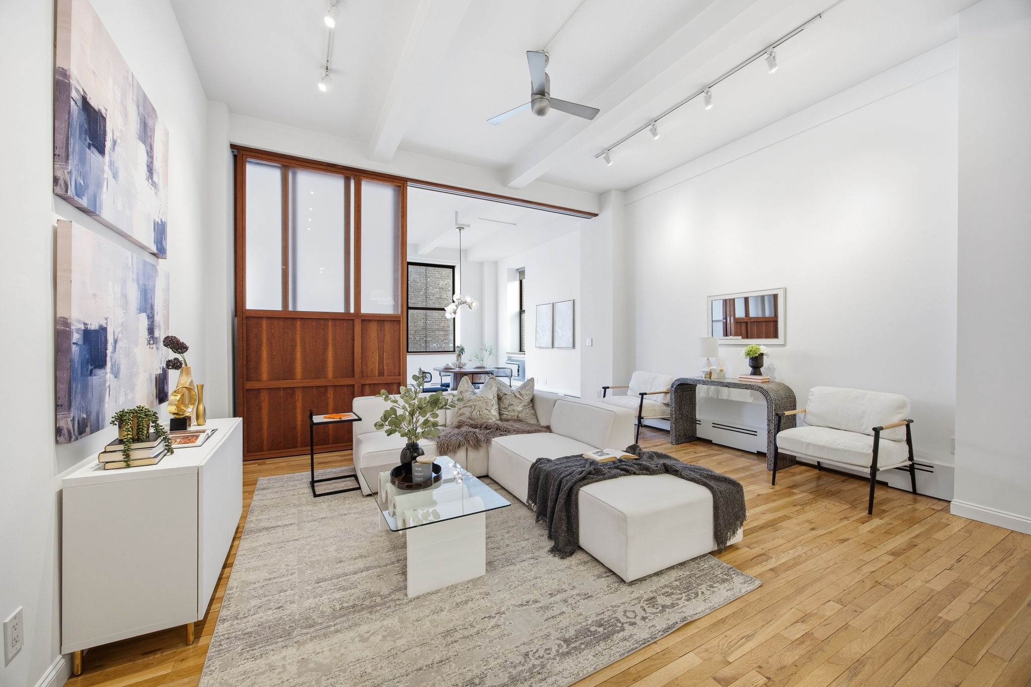 114 East 13th Street, Unit 6B Manhattan, NY 10003 - Photo 1 of 12 a living room with furniture and a large window