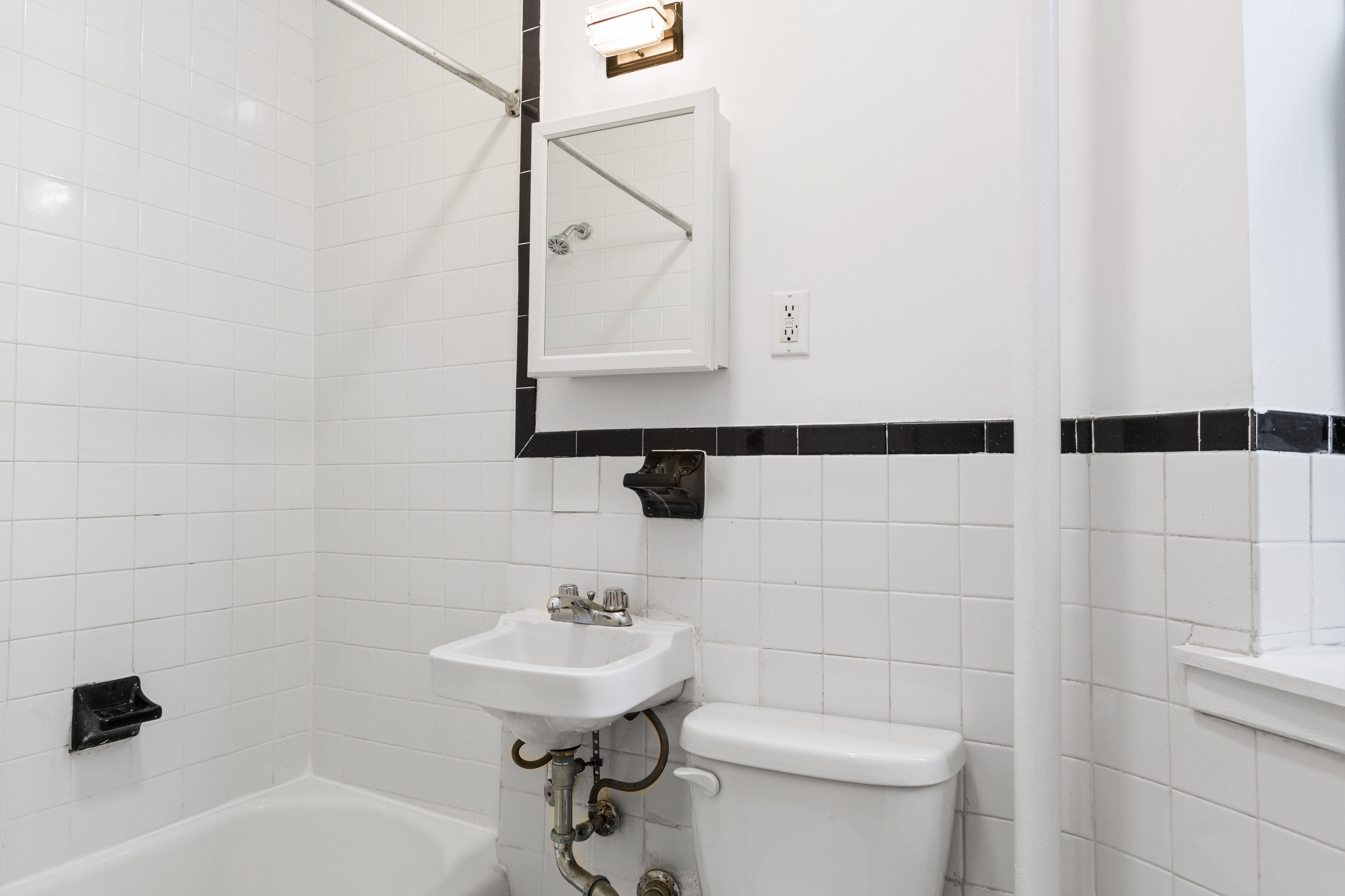 1775 Madison Avenue, Unit 1A Manhattan, NY 10035 - Photo 4 of 10 a bathroom with a sink a toilet and shower