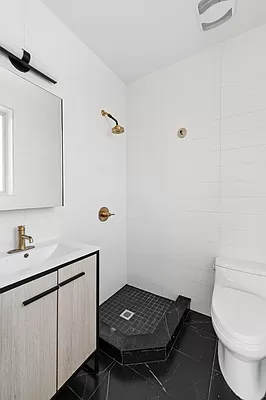 18 A Bleecker Street, Unit 4B Brooklyn, NY 11221 - Photo 9 of 11 a bathroom with a sink toilet and mirror