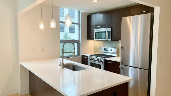 a kitchen with stainless steel appliances a refrigerator a sink a stove and microwave