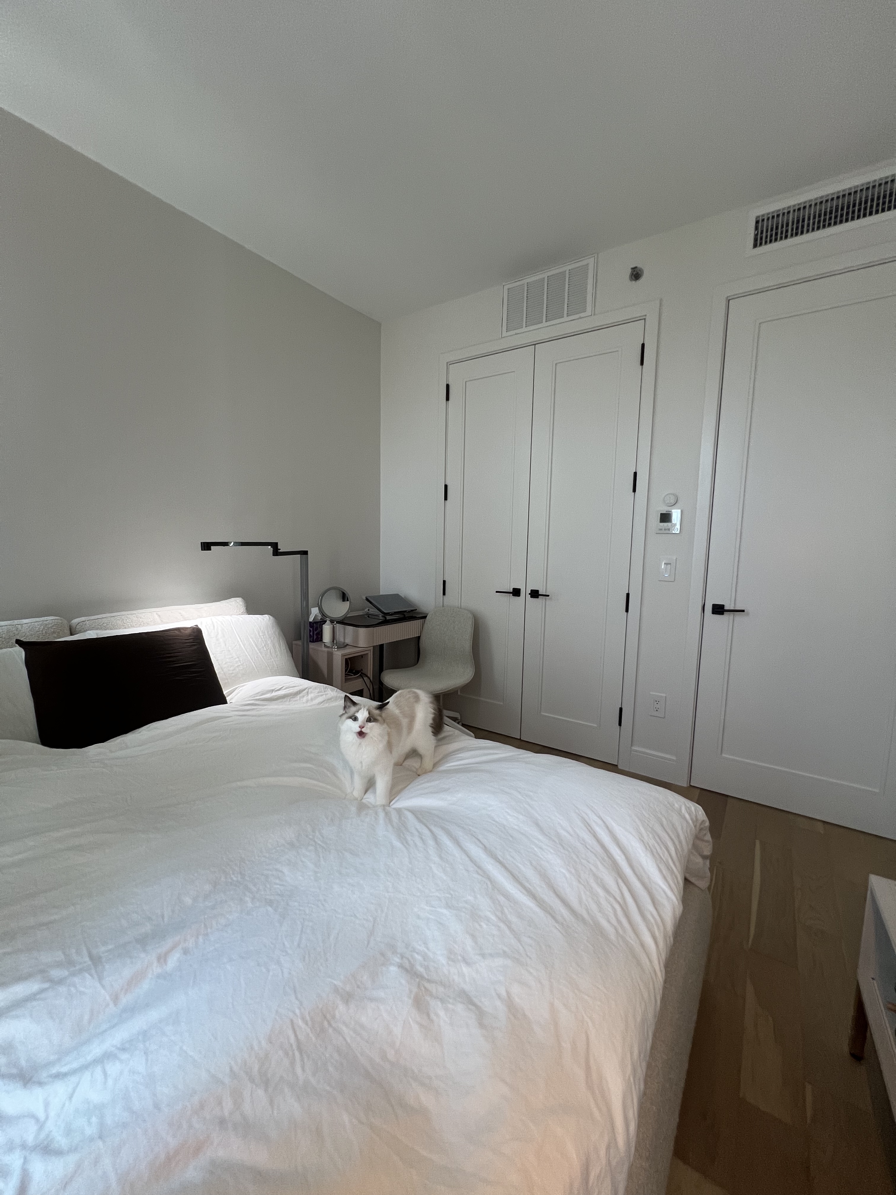 37-34 33rd Street, Unit 7H Queens, NY 11101 - Photo 2 of 18 a bedroom with a bed and a night stand