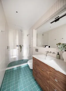 a bathroom with a double vanity sink a toilet and a mirror