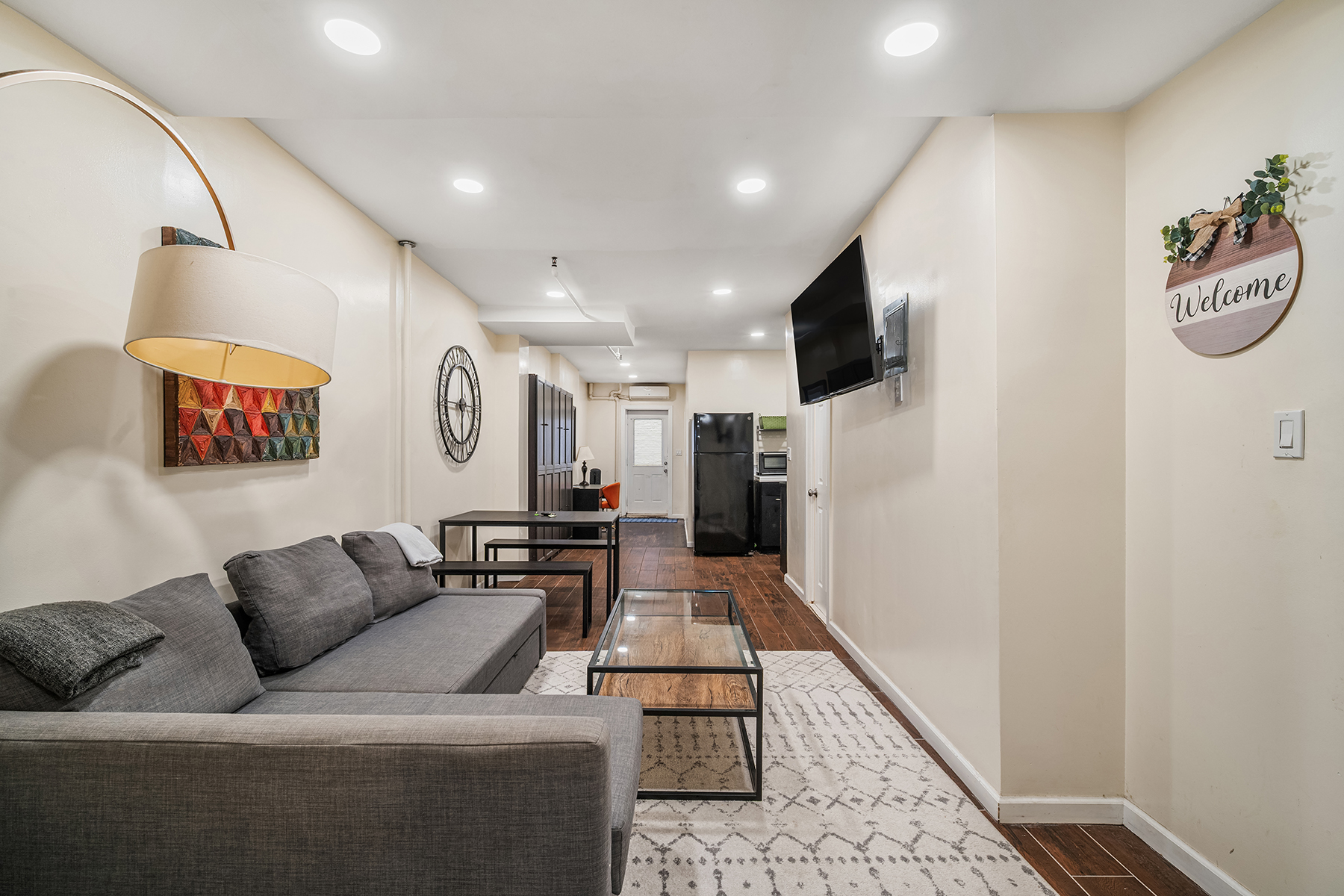 596 West 152nd Street Manhattan, NY 10031 - Photo 8 of 9 a living room with furniture and a flat screen tv