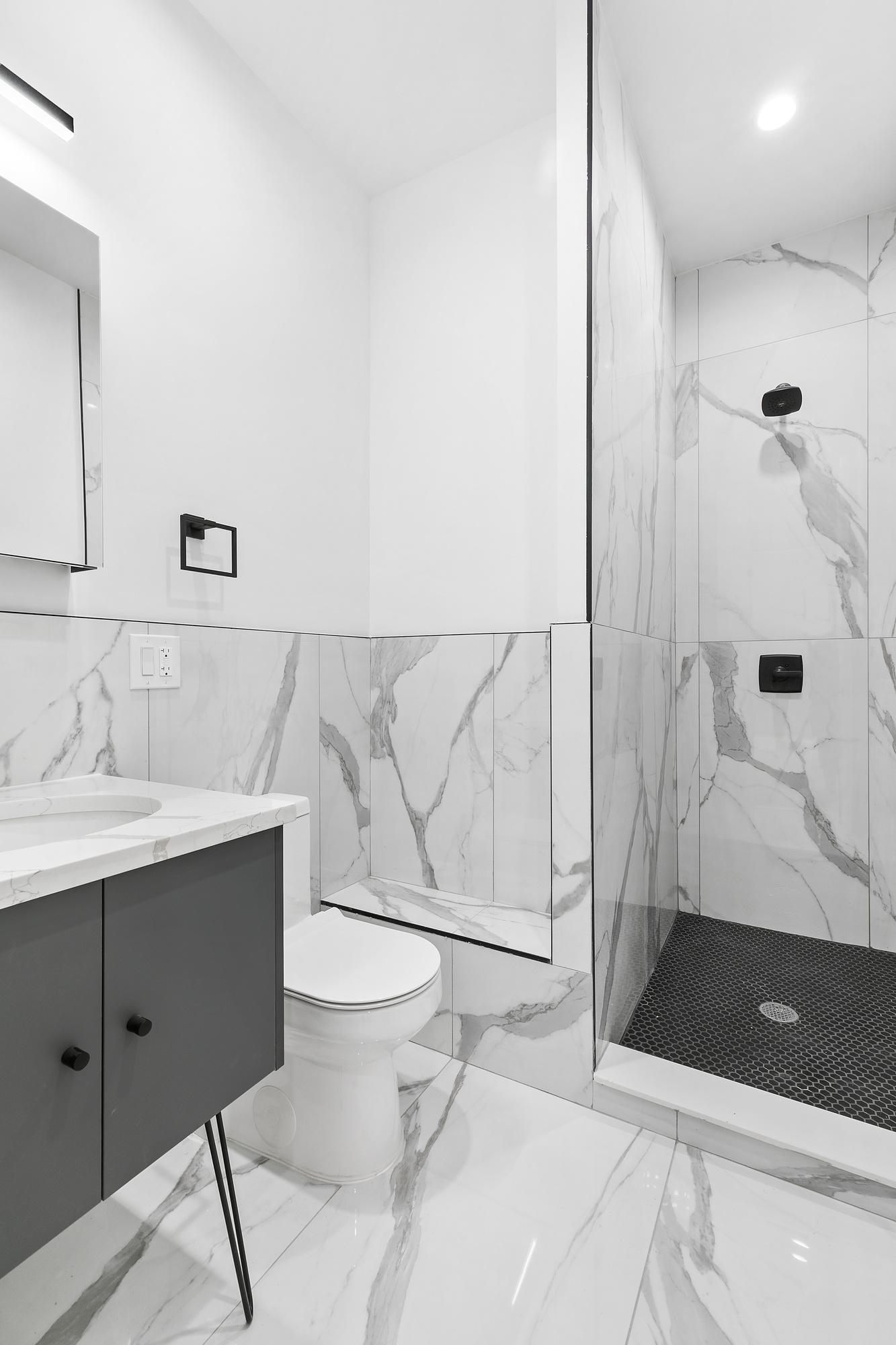 162 Cornelia Street, Unit 1 Brooklyn, NY 11221 - Photo 8 of 11 a bathroom with a sink a toilet and shower