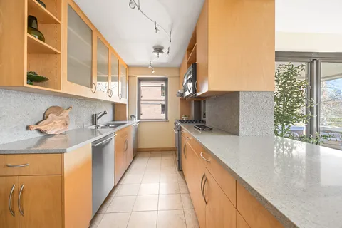 a kitchen with stainless steel appliances granite countertop a sink and a stove