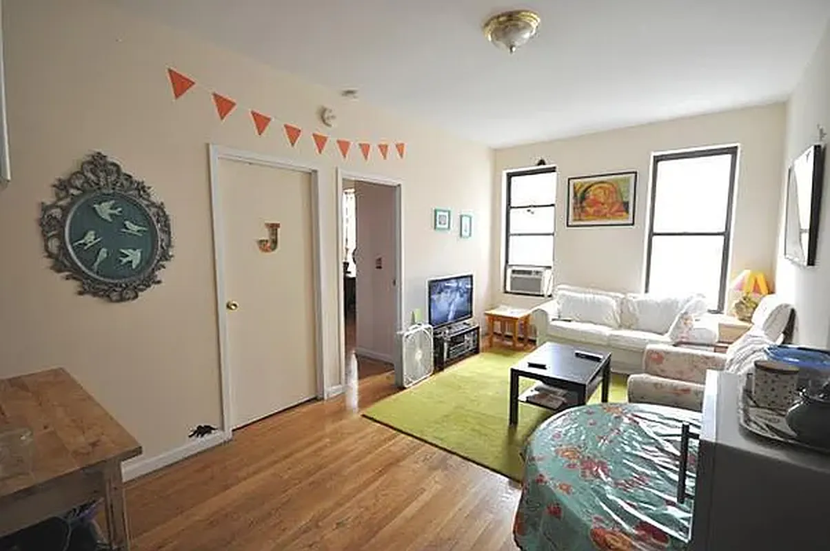 a living room with furniture a window and a table