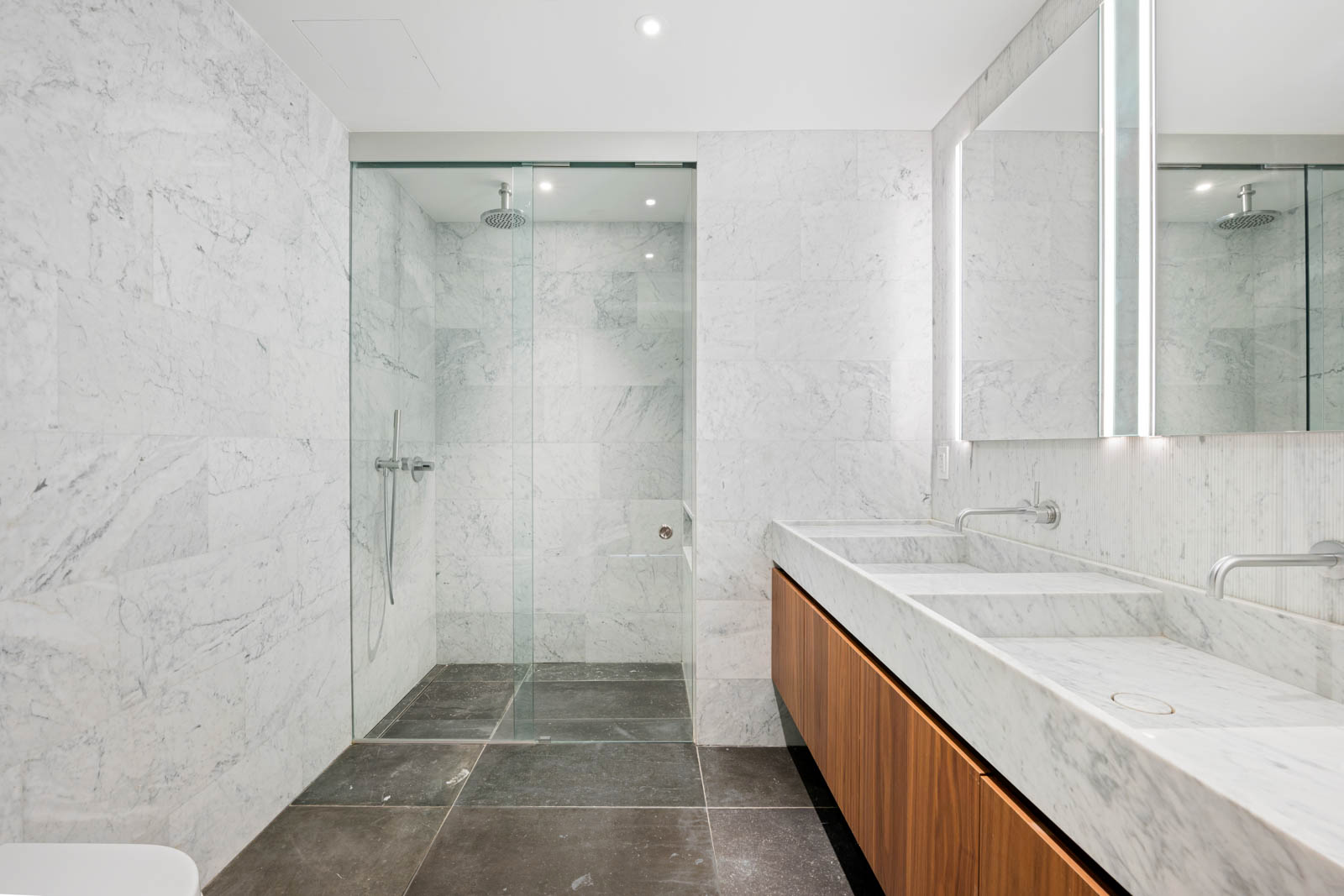 142 West 19th Street, Unit TH Manhattan, NY 10011 - Photo 5 of 10 a bathroom with a granite countertop sink mirror double and shower