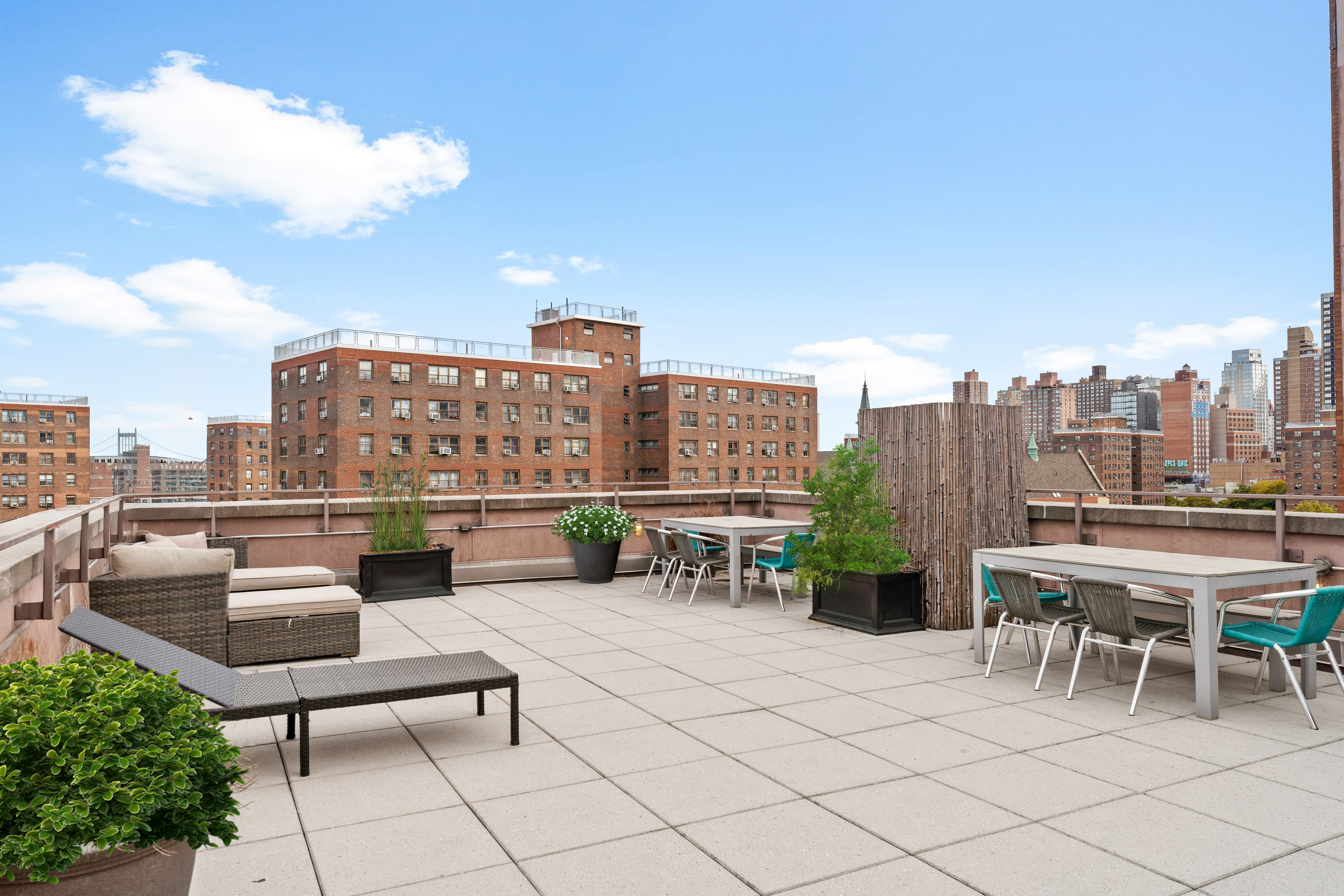 1810 3rd Avenue, Unit A9B Manhattan, NY 10029 - Photo 14 of 16 a roof deck with table and chairs and potted plants