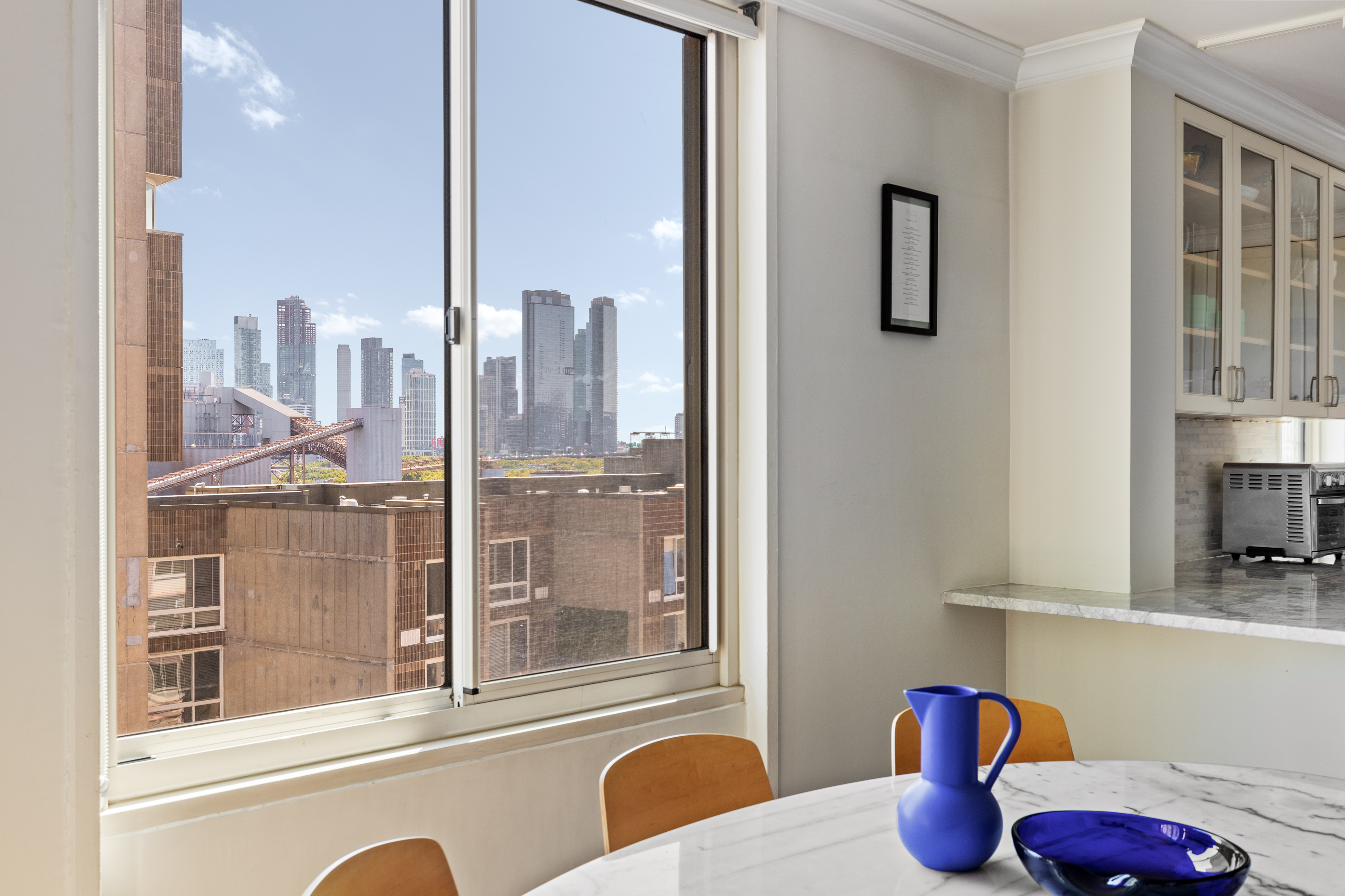 575 Main Street, Unit 1312 Manhattan, NY 10044 - Photo 5 of 25 a bathroom with a granite countertop sink and a mirror