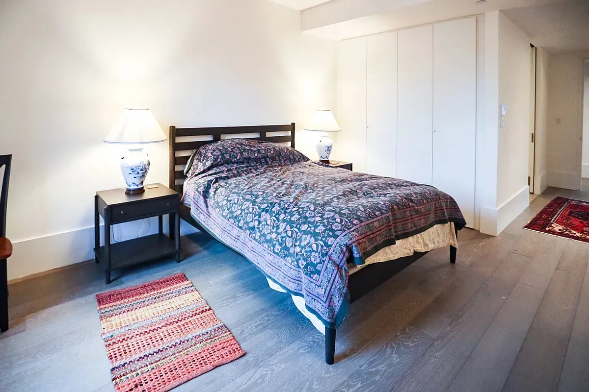 a bedroom with a bed and a table