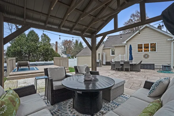 a view of a patio with couches table and chairs and potted plants