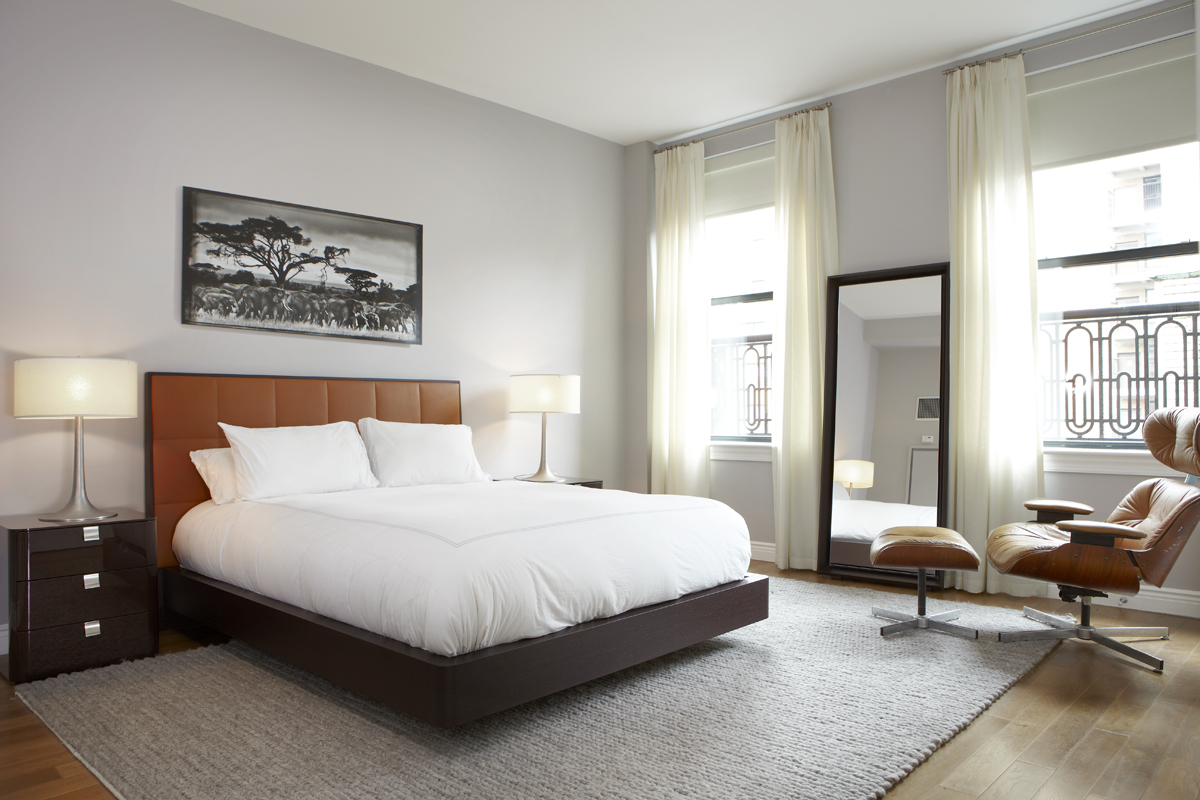 225 5th Avenue, Unit 11A Manhattan, NY 10010 - Photo 5 of 13 a bedroom with a bed a lamp on desk and a window