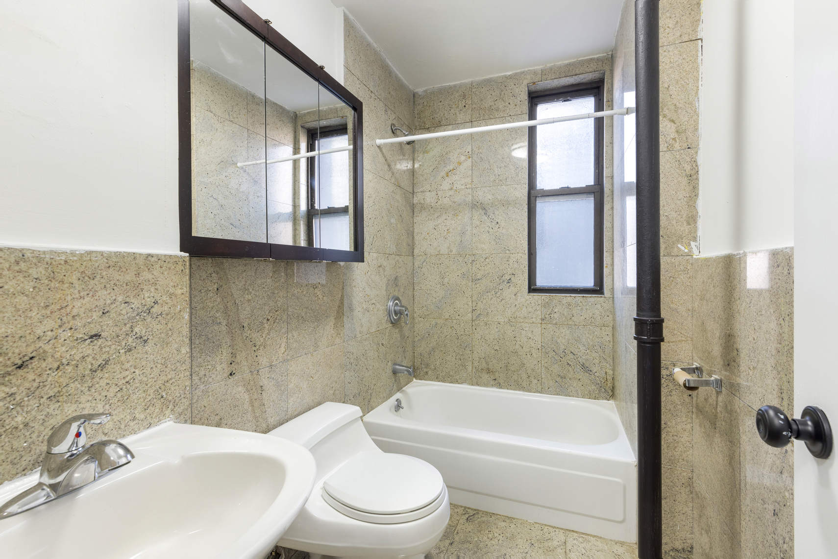 24 East 97th Street, Unit 10 Manhattan, NY 10128 - Photo 6 of 7 a bathroom with a sink toilet and shower
