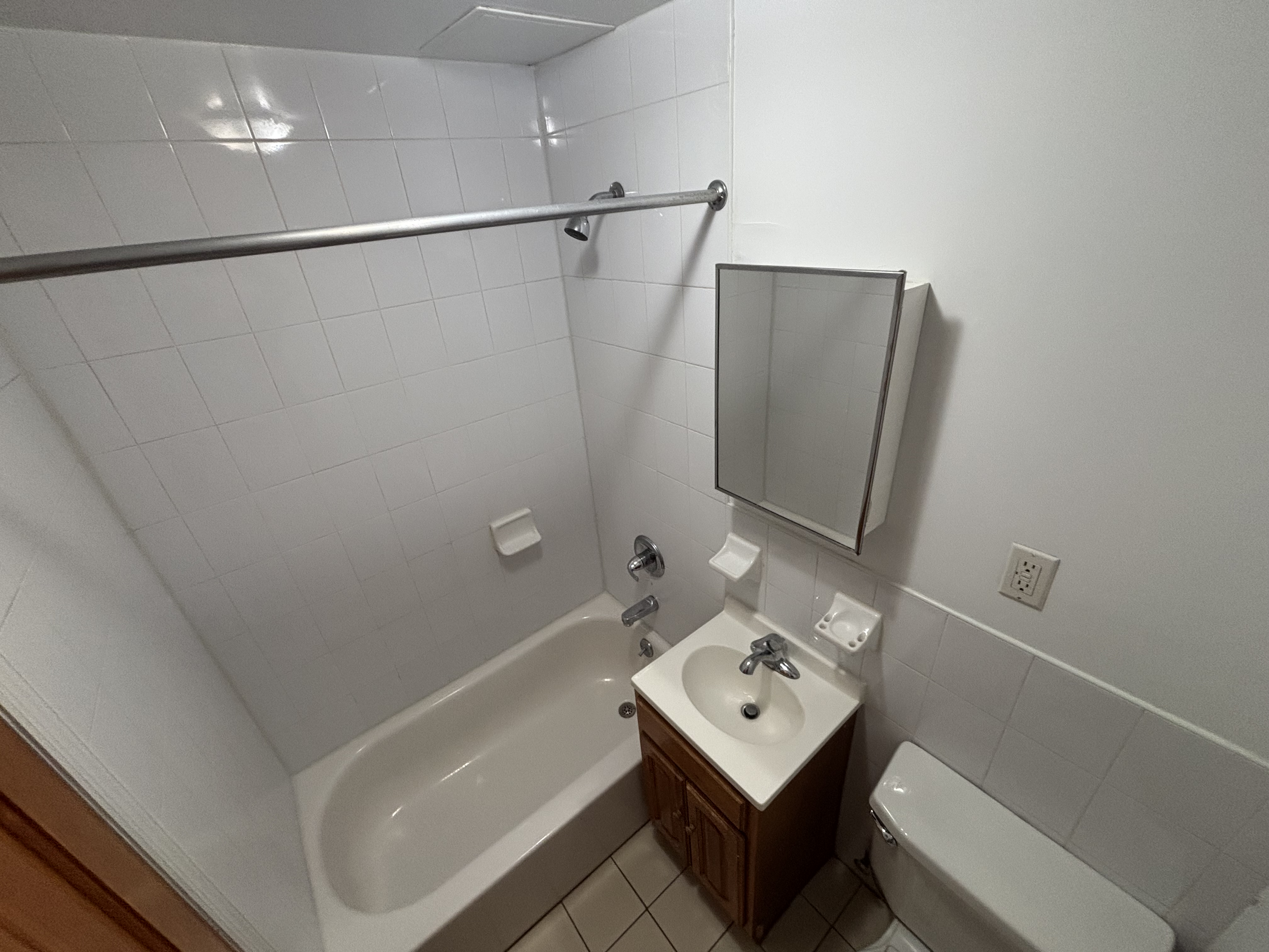 99 St Marks Place, Unit 4B Manhattan, NY 10009 - Photo 9 of 10 a bathroom with a tub sink and mirror