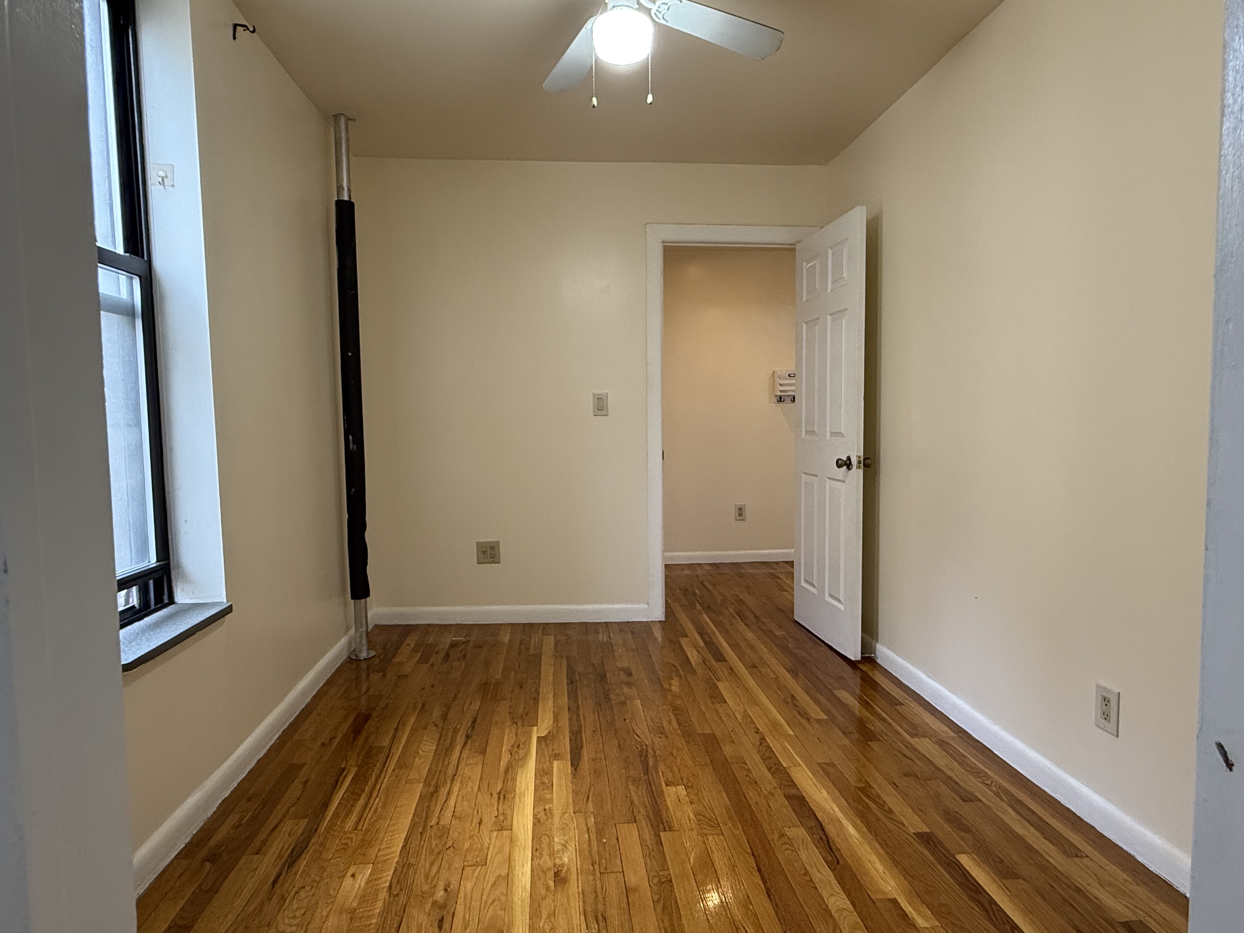 Park Avenue Manhattan, NY 10035 - Photo 10 of 14 a view of a room with wooden floor and door