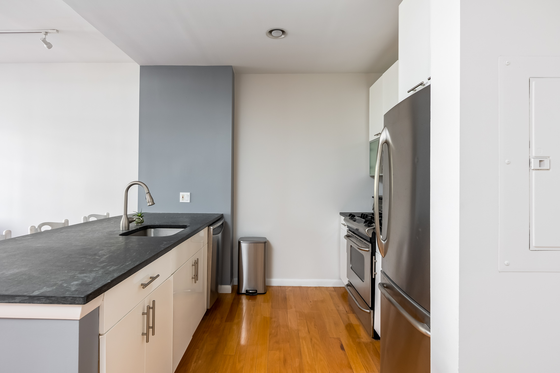 48-21 5th Street, Unit 3H Queens, NY 11101 - Photo 4 of 10 a kitchen with a sink and a refrigerator
