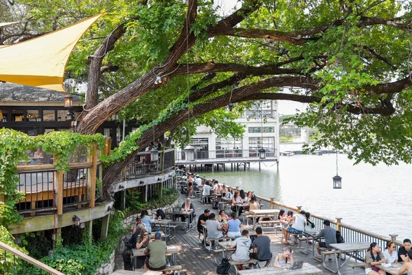 a view of a lake from a balcony with chairs
