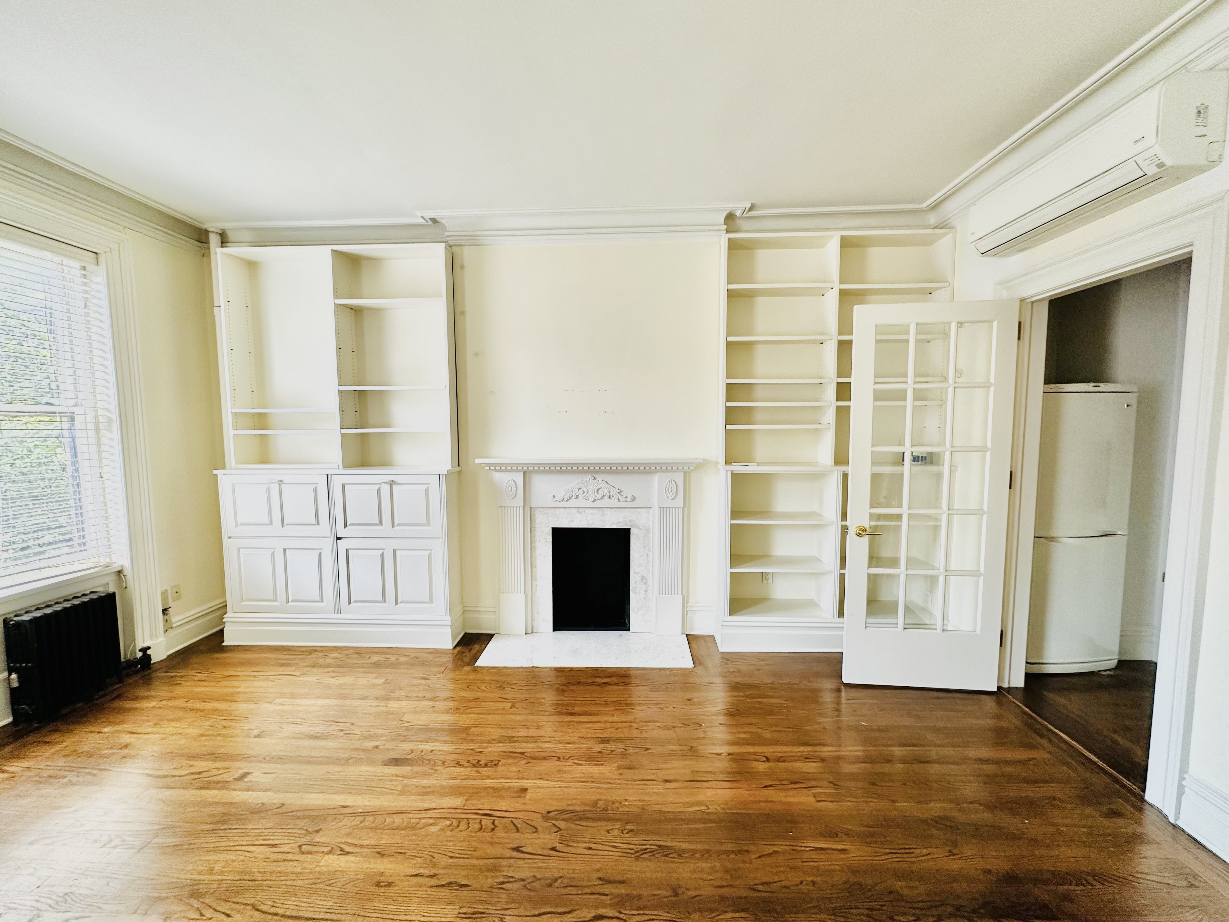 28 West 10th Street, Unit 4R Manhattan, NY 10011 - Photo 2 of 7 a view of an empty room with a fireplace and a window
