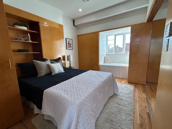 a bedroom with bed and window