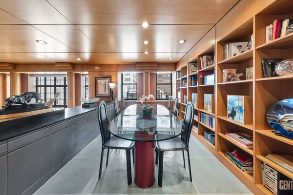 a dining room with furniture and a book shelf