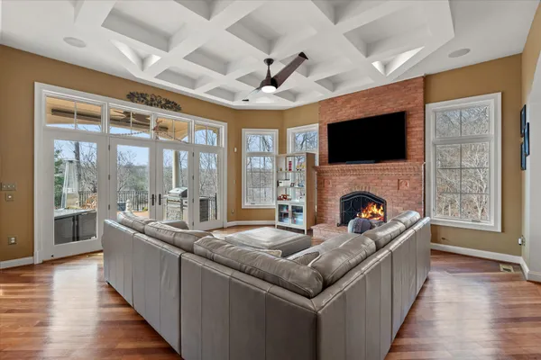 a view of a livingroom with wooden floor and a chandelier