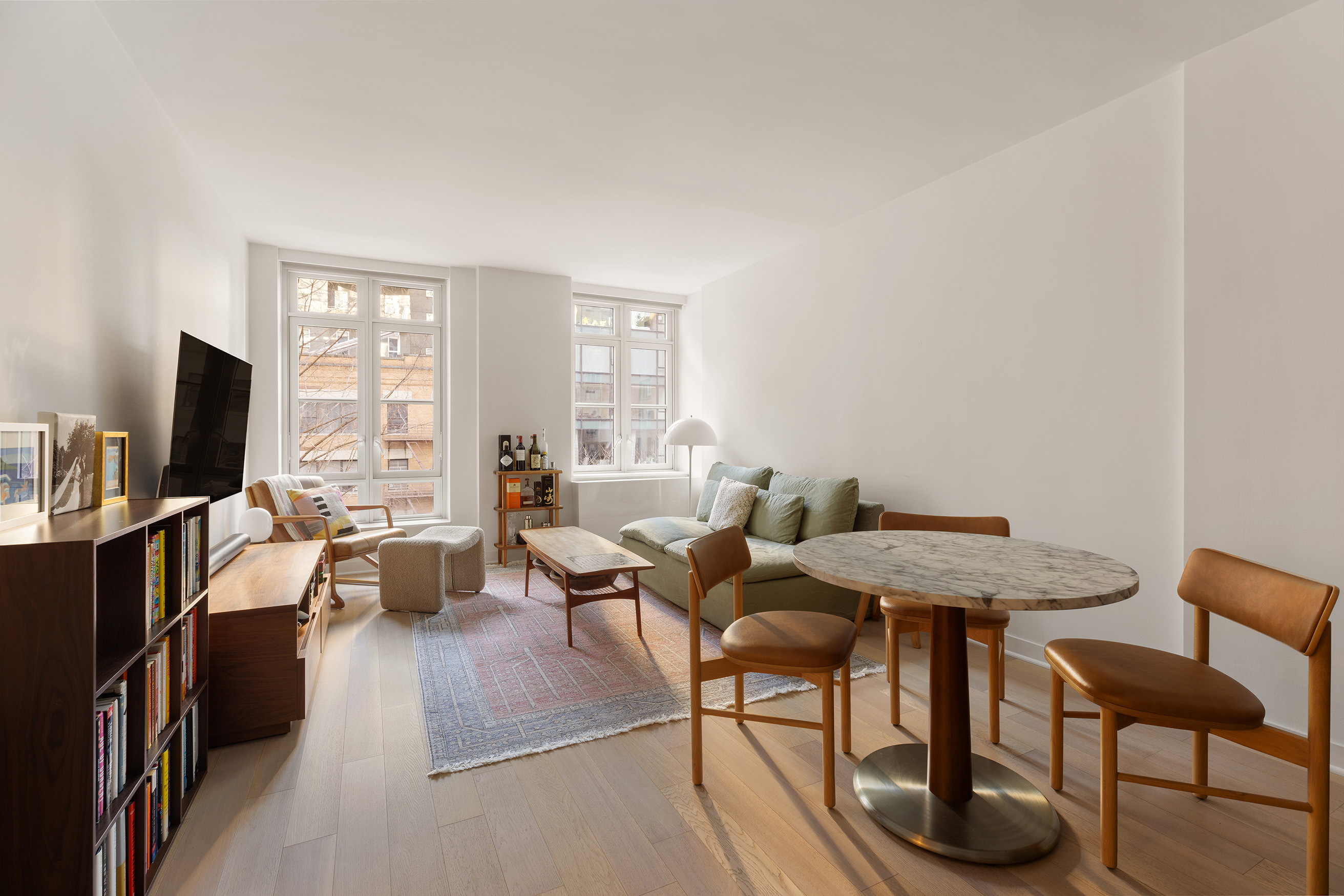 261 Hudson Street, Unit 5S Manhattan, NY 10013 - Photo 1 of 6 a view of a livingroom with furniture and a flat screen tv