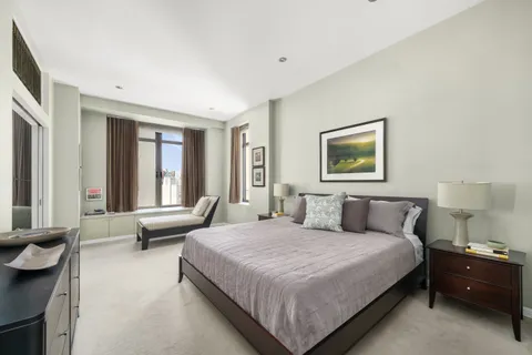 a bedroom with a bed and a couch