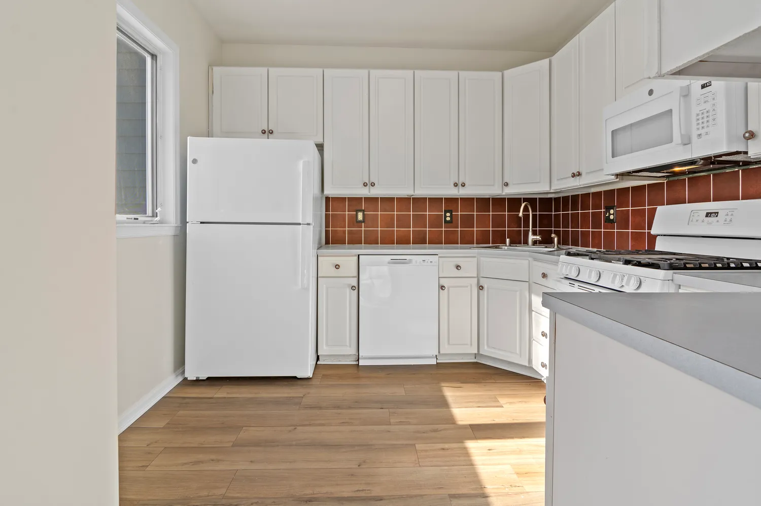 a kitchen with a refrigerator a sink and cabinets
